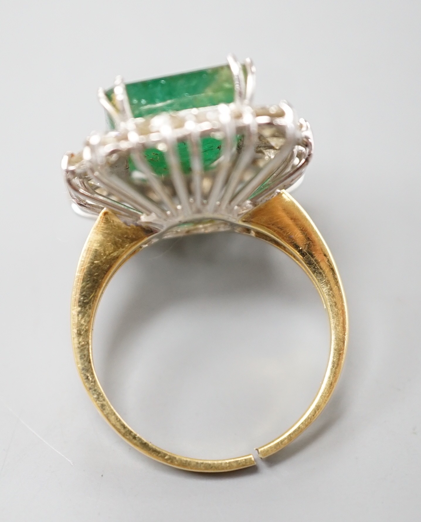 A yellow metal, emerald and diamond set rectangular cluster ring (shank cut), size M, gross weight 7.9 grams